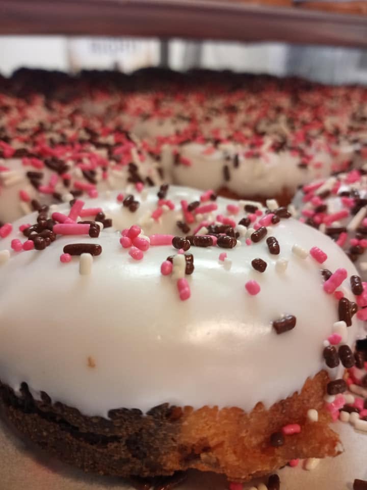 Close-up of a glazed sprinkle donut