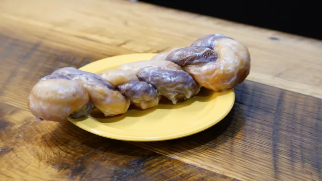 A long glazed twist with alternating golden and dark dough sections.